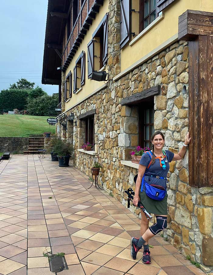 hiker posing in front of historic hotel